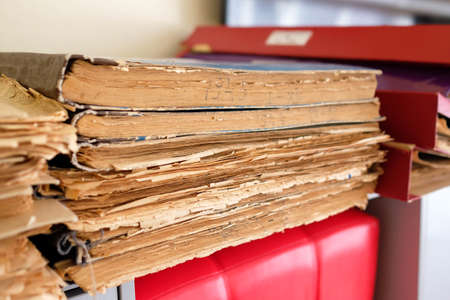 Files of old newspapers in the library. Edge of big books with old paper.