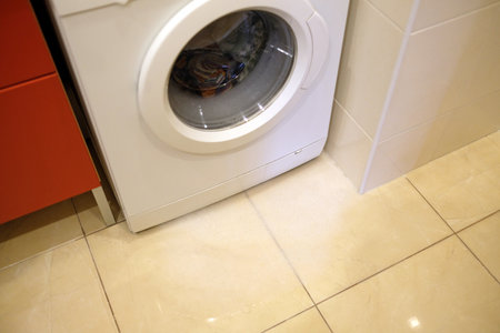 There is a problem with the washing machine. Foam and water at the bottom of the machine.の写真素材