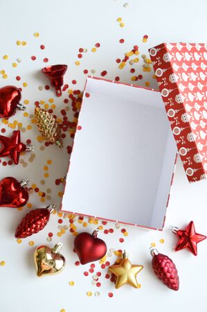 Beautiful red box for new year and Christmas gift. Gift in a red box with a pattern of white balls. Red box on white background. Preparation for the holiday. Merry Christmas and happy New year gift.の写真素材
