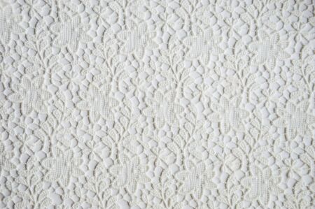 texture of white openwork fabric on a white background.