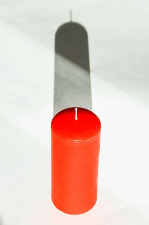 red wax candle on a white background.の写真素材