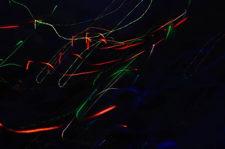 Abstraction. neon, background for the design. colored lines on a dark background.