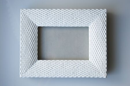 white photo frame on a gray background.