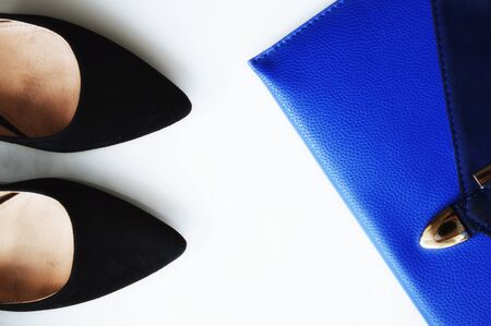 Blue bag and black classic women's shoes on a white background.の写真素材