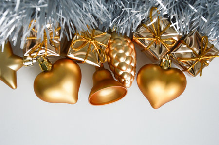 Merry Christmas and Happy New Year. golden holiday toys for decoration on a white background. postcard for winter greetings.の写真素材