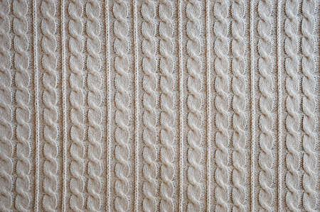 background for the design. the texture of the knitted fabric. braids are knitted with woolen...