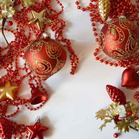 red balls for the Christmas tree and beads for decoration for winter holidays on a white background....