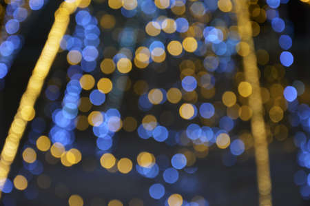 the bokeh lights are yellow and purple. very peri festive shiny background for celebrating Merry...