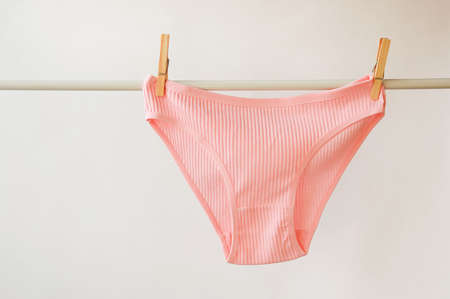 women's underwear. pink underpants on a light background. a piece of clothing for a person.の写真素材