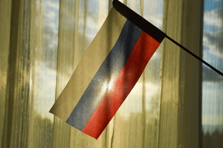 the flag of Russia on the background of a sunny window.の写真素材