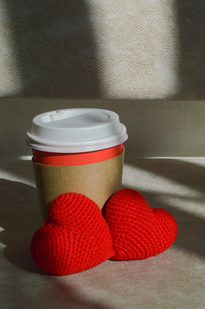 a glass for hot drinks, tea and coffee. background for the design. two red hearts, valentine's day, love.の写真素材