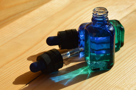 glass bottle with pipette for cosmetics and essential oils. blue background for decoration.の写真素材