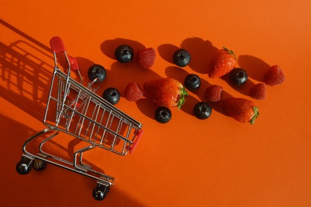 fresh, ripe berries, raspberries, strawberries and blueberries in the shopping cart. proper nutrition. vitamin food. background for the design.の写真素材