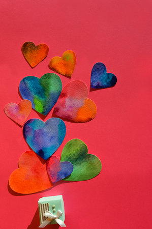 Colorful hearts and gift box on red background. top view.の写真素材