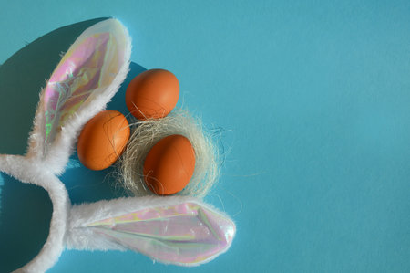 Easter eggs with rabbit ears on blue background. Happy Easter concept.の写真素材