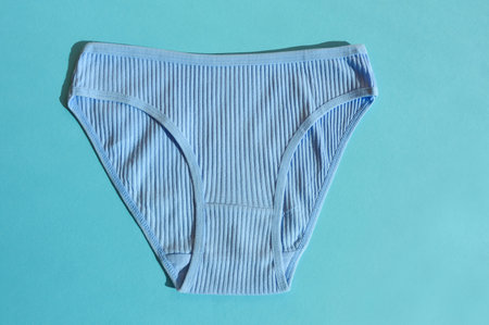 Women's panties on a blue background. Flat lay, top view.の写真素材