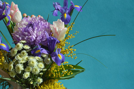 Bouquet of spring flowers on a turquoise background.の写真素材