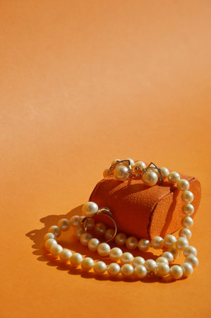 pearl jewelry, beads around the neck, a gold ring with pearls and earrings. women's necklace. background for the design.の写真素材