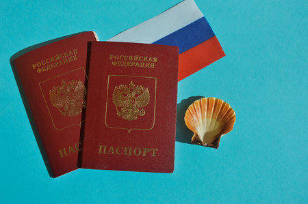 Russian biometric passport with Russian flag and seashell on blue backgroundの写真素材