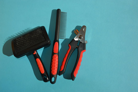 Set of hairdresser tools on blue background, top view