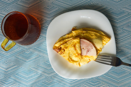 chicken egg omelet with ham and cheese. food for breakfast. background for the designの写真素材