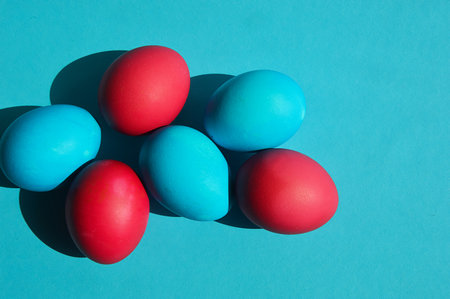 Colorful Easter eggs on turquoise background. top view.の写真素材