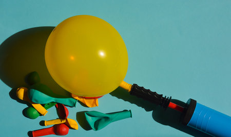 Yellow balloon and plastic on blue background. minimal concept.の写真素材
