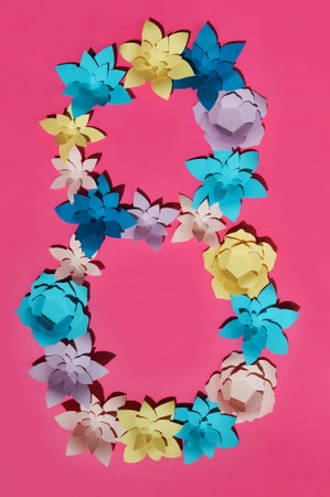 Paper flowers of different colors on orange background. paper cut flowers.の写真素材