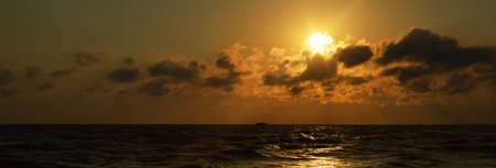 sunset on the sea, clouds in the sky, beautiful nature. background for the designの写真素材