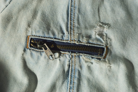 Blue jeans texture with zipper and key in pocket close-up.