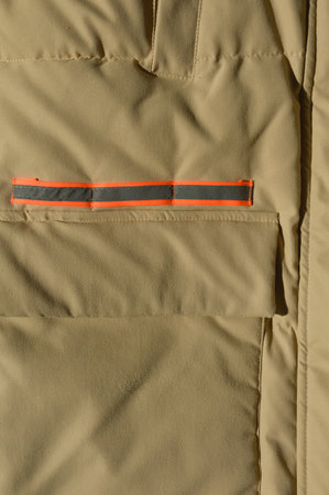 Fragment of the military jacket with a red ribbon as a backgroundの写真素材