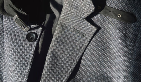 Men's jacket with buttons on a black background. Close-up.の写真素材