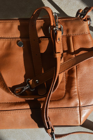 Leather handbag close-up on the background of the sunの写真素材