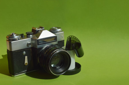 Old camera on green background. Vintage camera on a green background.の写真素材