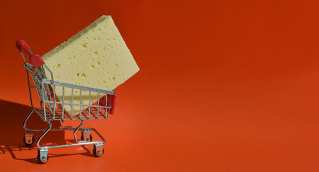 The cheese is in the shopping cart. selling food in the store. background for the design. dairy productの写真素材