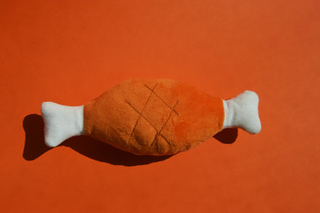 Sausage in the form of a fish on a red background