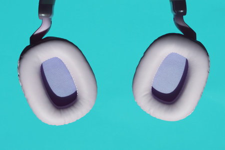 Earphones isolated on a blue background. Earphones on a blue background.の写真素材