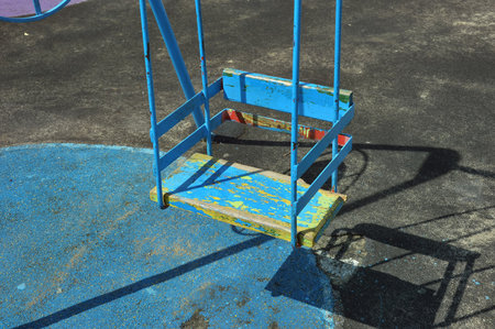 Old children's swing on the playground, close-up of photoの写真素材