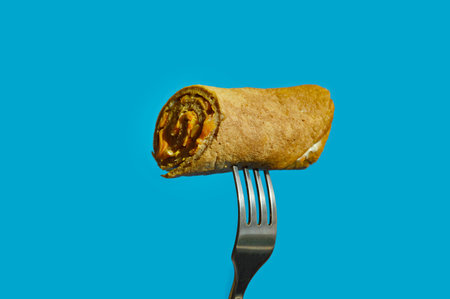 Food on a fork on a blue background.の写真素材