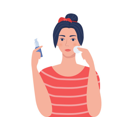 Young woman cleaning her face with cotton pad, holding cleaning lotion in her hand. Beauty, skin care and cosmetic concept. Vector illustration in flat styleのイラスト素材