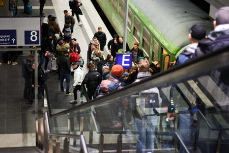 Berlin / Germany - 01 05 2020: People at a railway station are boarding the train from the platform