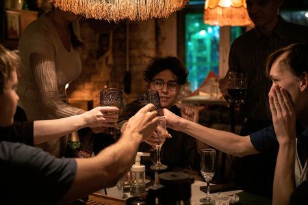 Nizhniy Novgorod Russia-09/05/2020: Cheerful happy friends clinking glasses at evening corporate eventのeditorial素材