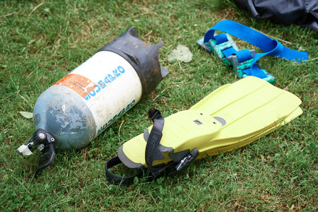 Scuba tank and flippers for scuba diving lie on the grass, concept active lifestyle, extreme sports....