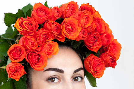 Portrait of the laughing red-haired girl with orange roses