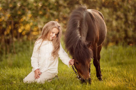 Young girl with her ponyの写真素材