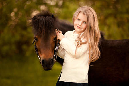 Young girl with her ponyの写真素材