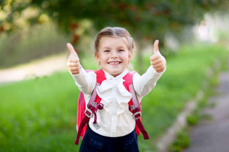 primary school girl with school backpack outdoorsの写真素材