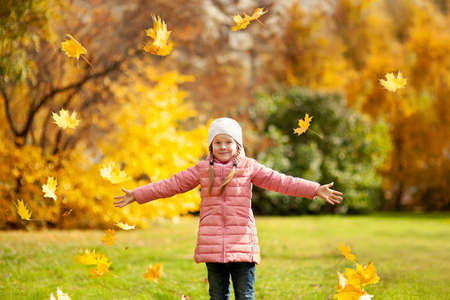 Adorable little girl and boy outdoors at beautiful autumn day
