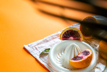 Orange juice concept through tropical leavesの写真素材