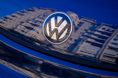 Volkswagen logo on a bright blue car, close up, city reflection - About January 2023, Bar, Montenegroのeditorial素材